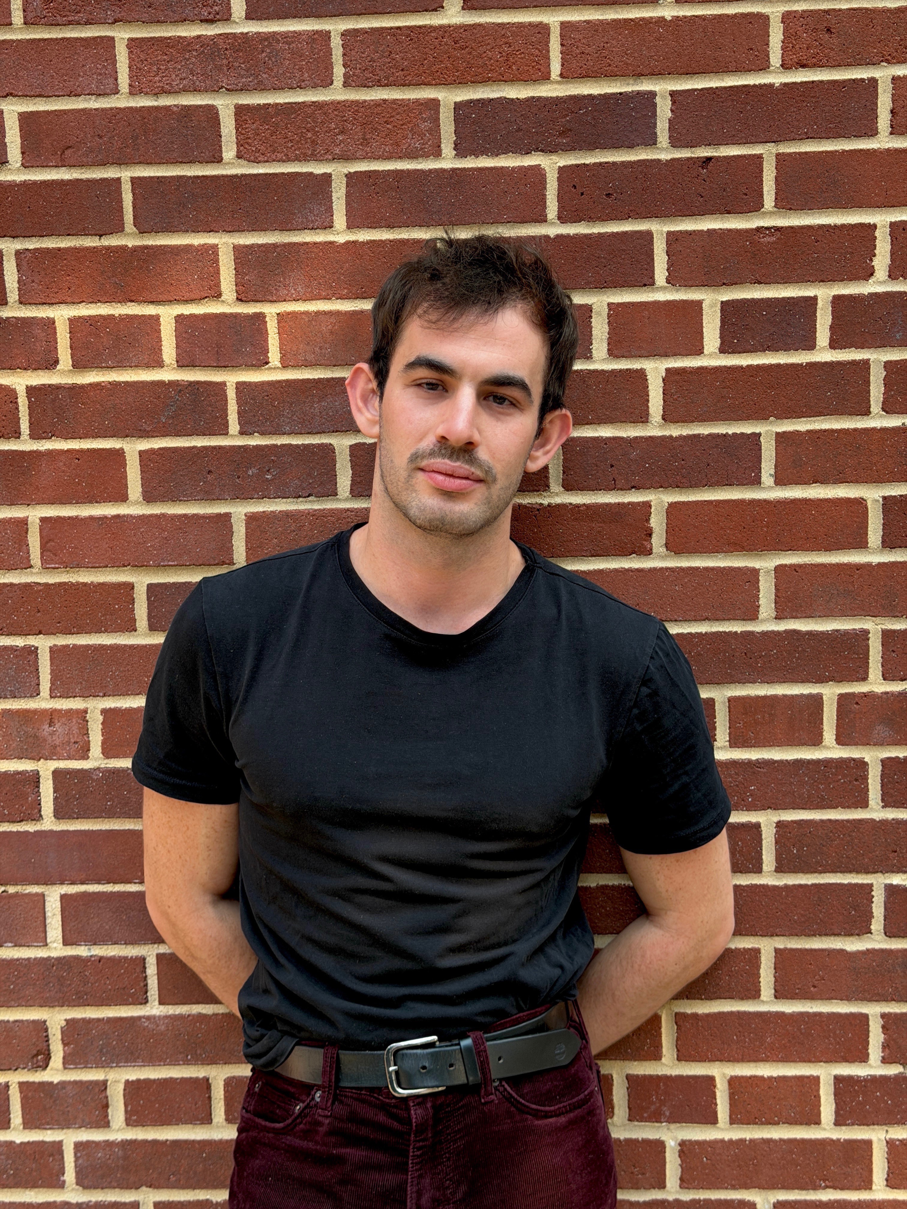 Headshot of Jared Harbour in front of a brick wall