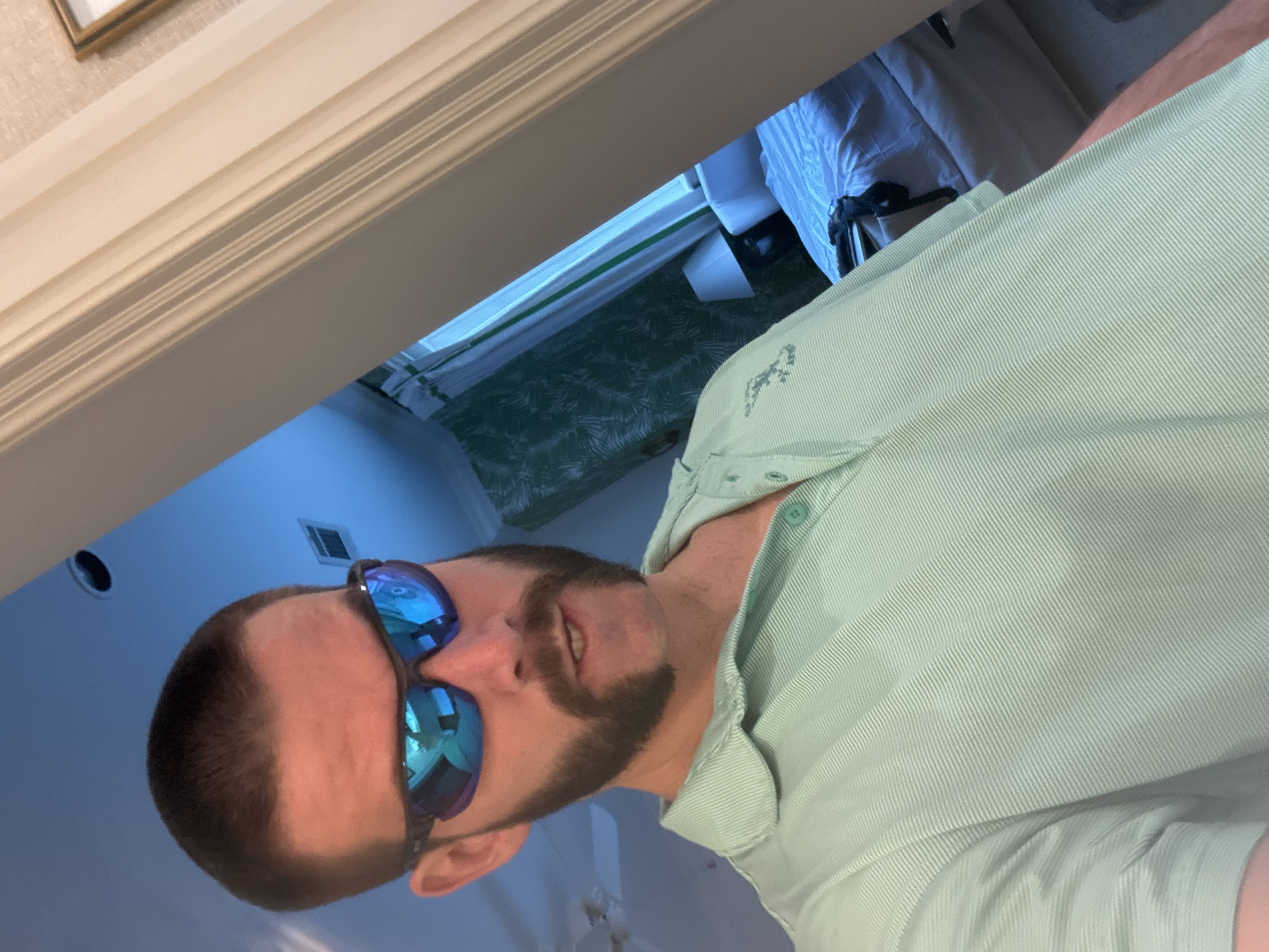 Headshot of Tennant Maxey wearing blue sunglasses