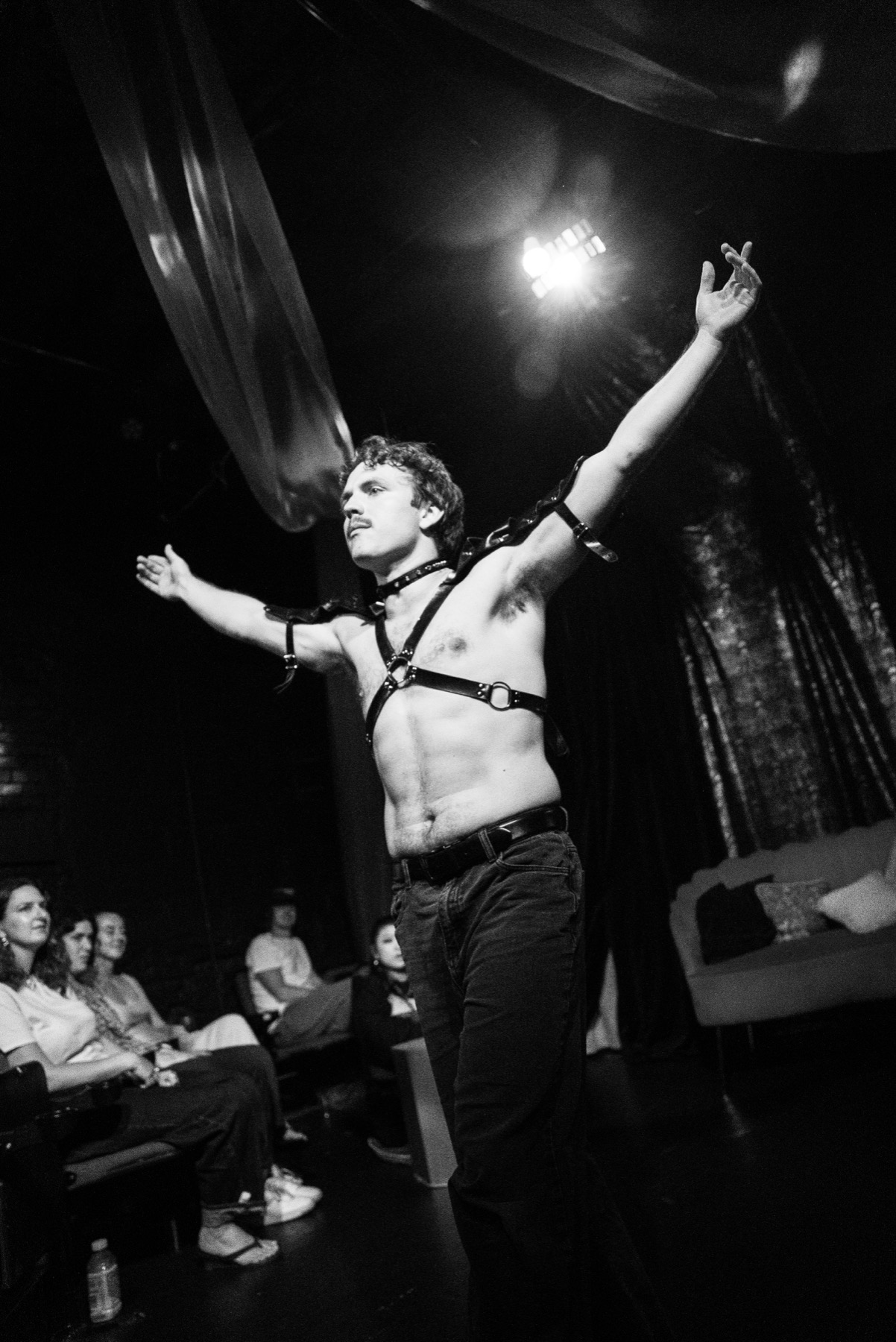 Yokanaan raises his arms in a black-and-white DECAPITATRIX production photo