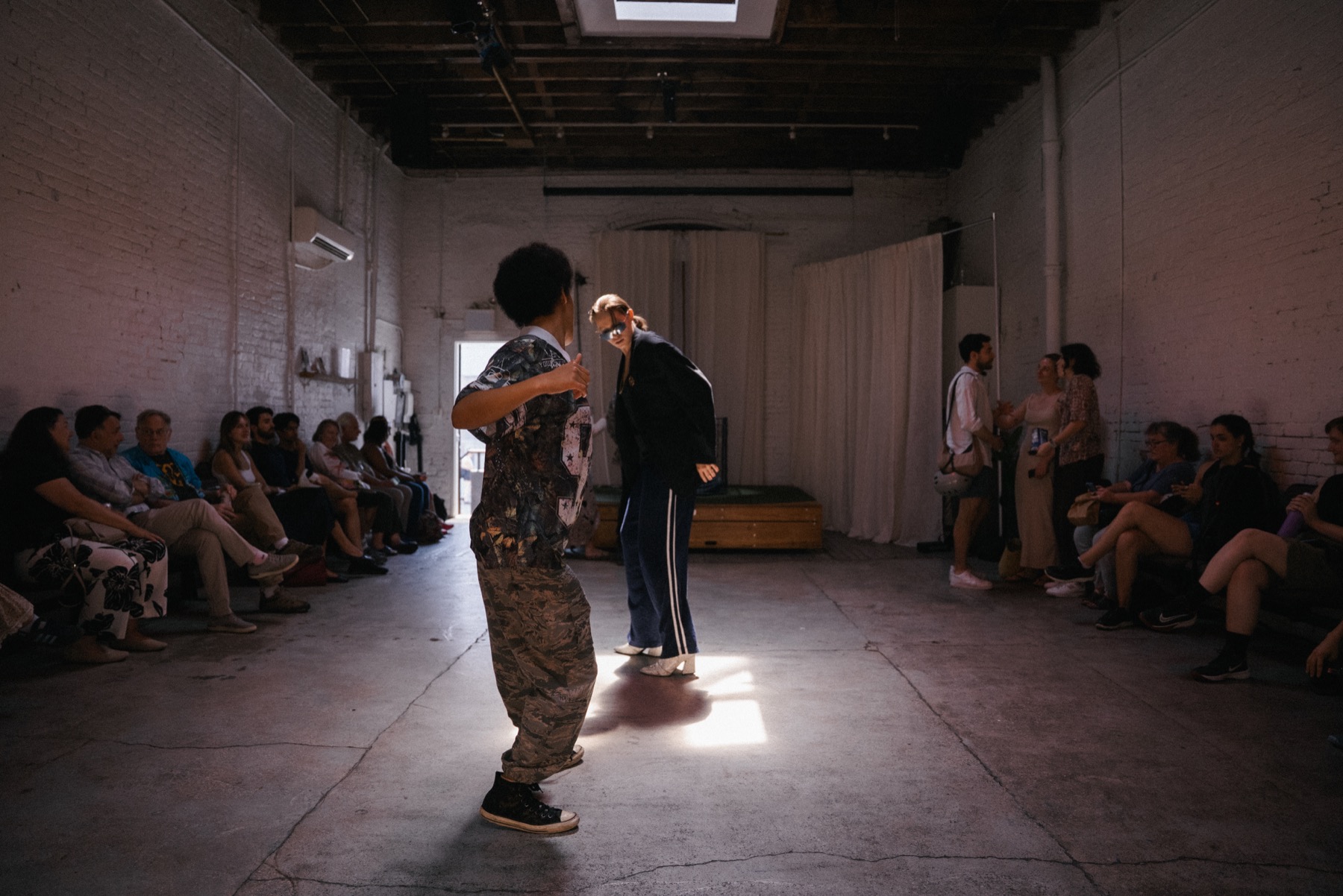 Audience seated around the room before DECAPITATRIX