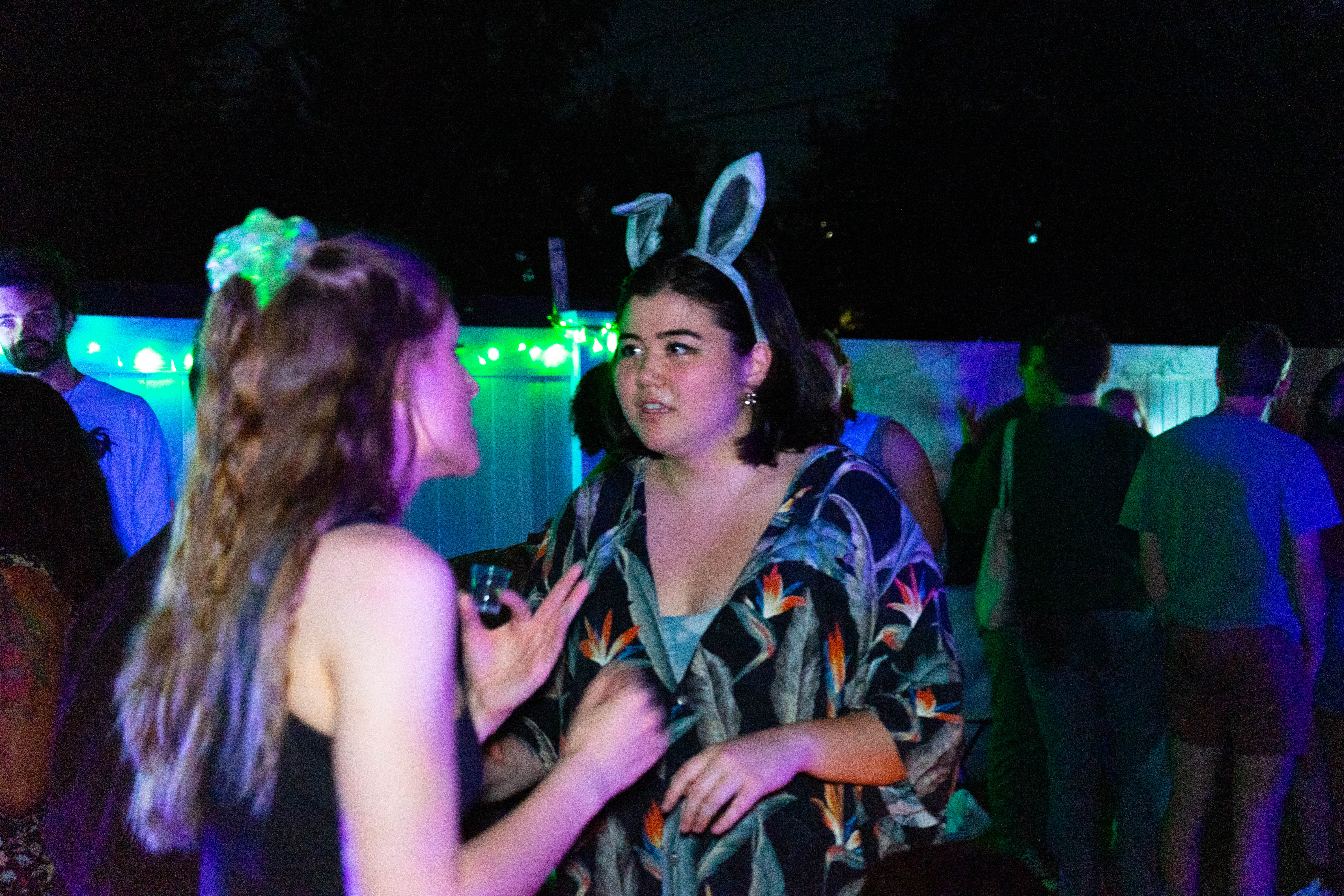 The lovers confront one another under colorful lights