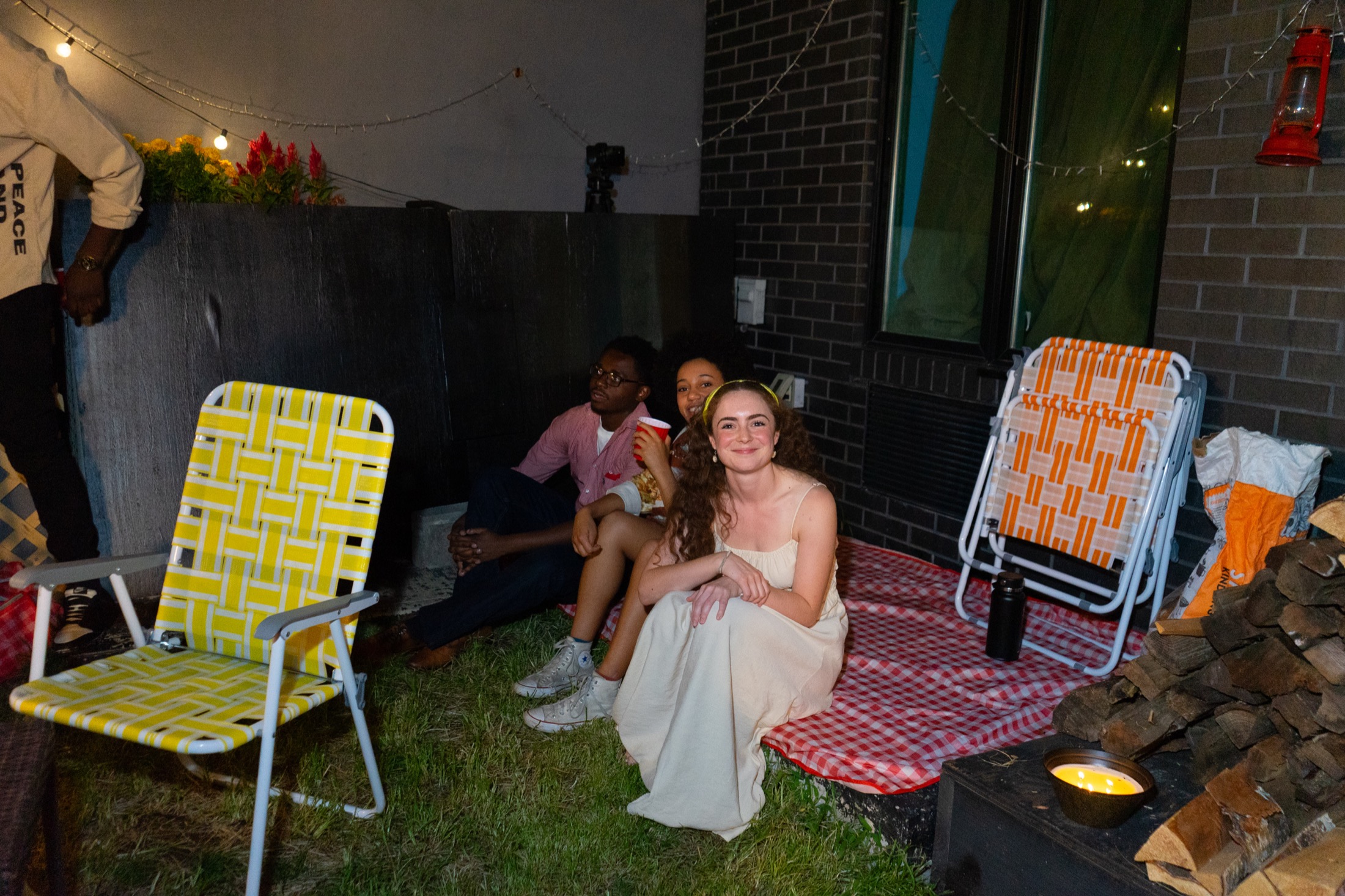 Charles Webb stands smiling in a backyard playing space