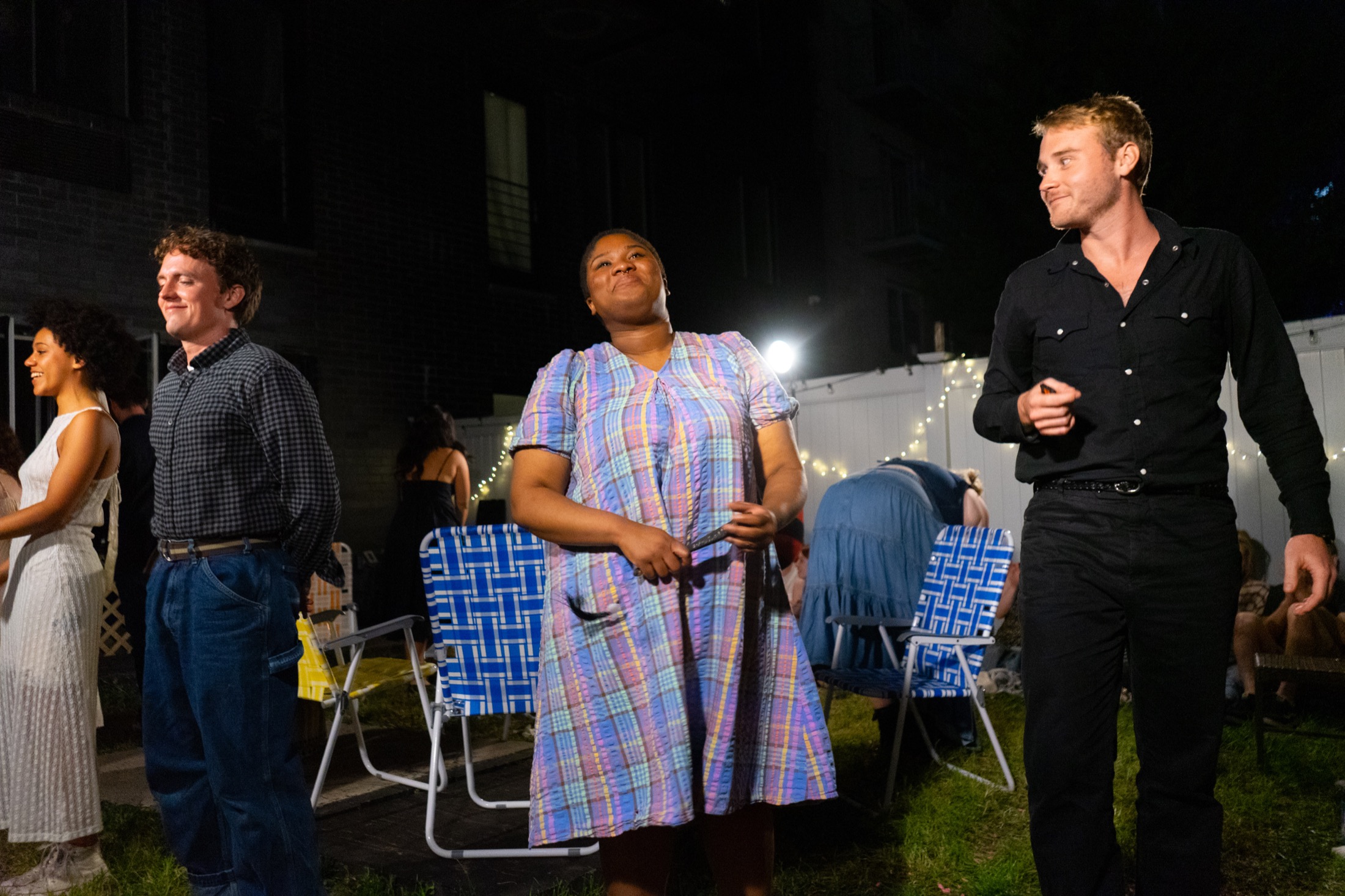 Doc Gibbs and Mrs. Soames stand near lawn chairs during Our Town