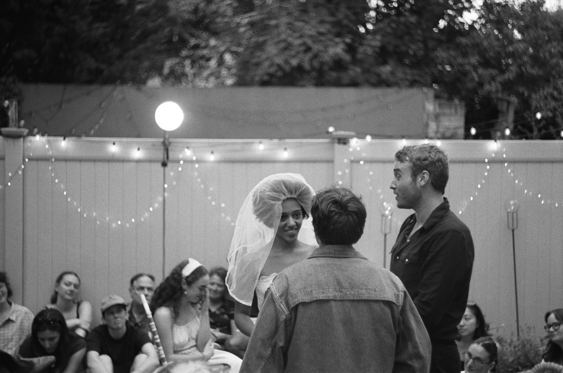 A black-and-white Our Town wedding scene with Emily Webb, George Gibbs, and the Stage Manager