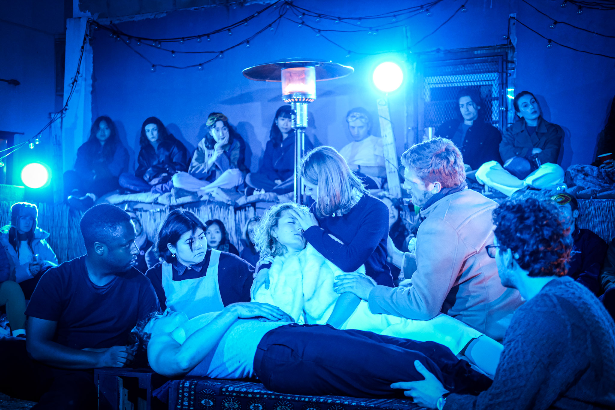 The company gathers around Romeo and Juliet in a blue-lit final tableau