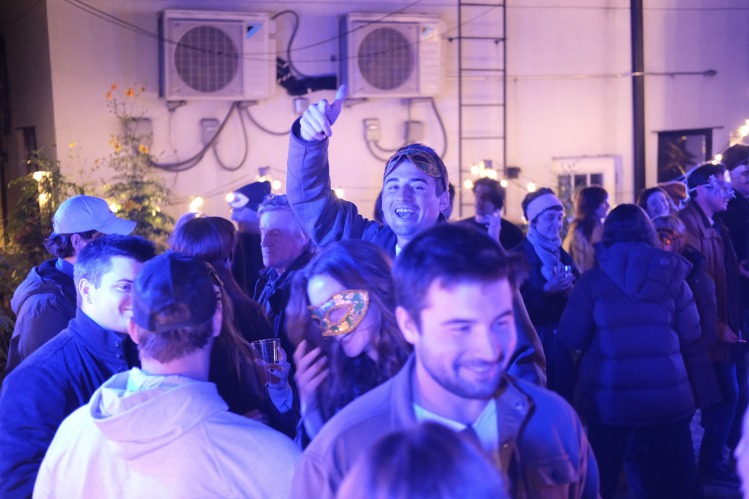 Masked party crowd under blue light at Romeo and Juliet