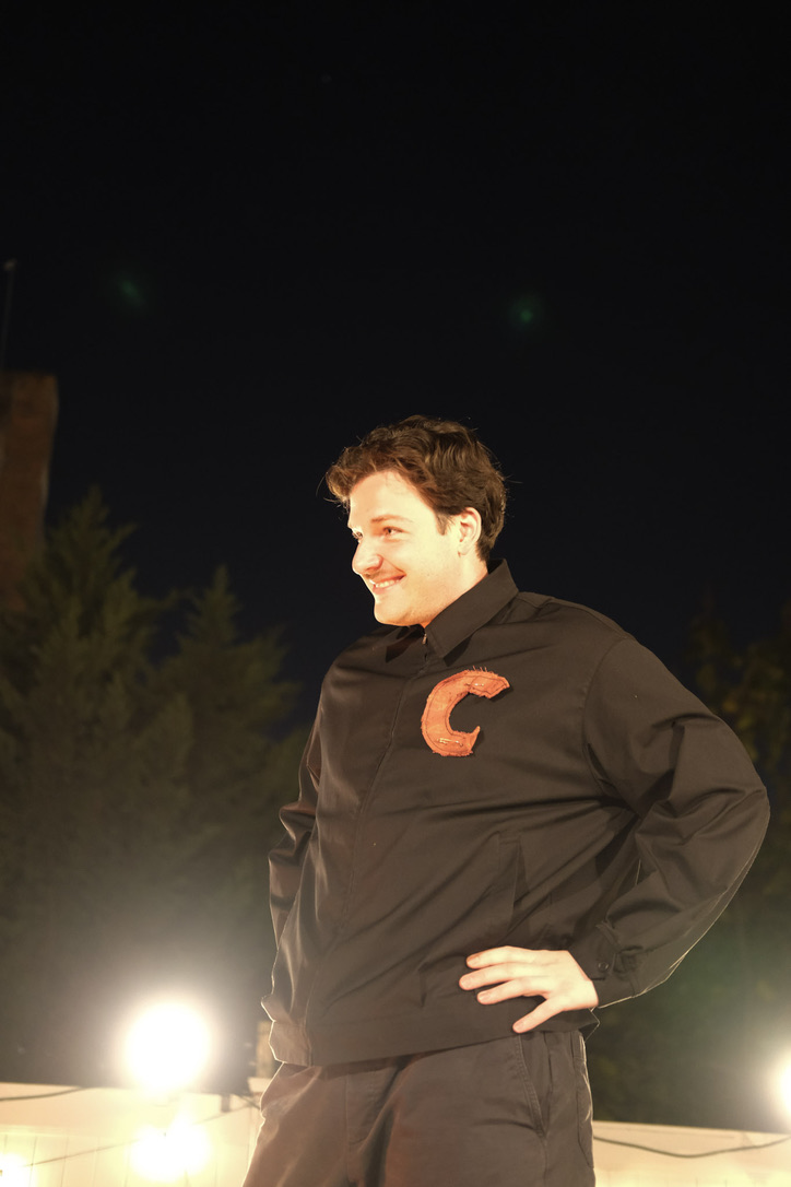 The Prince smiles under bright backyard lights