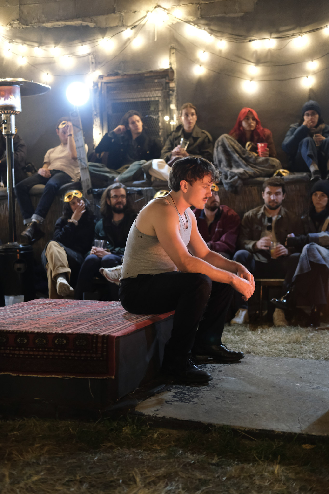 Romeo sits alone on a platform before the audience