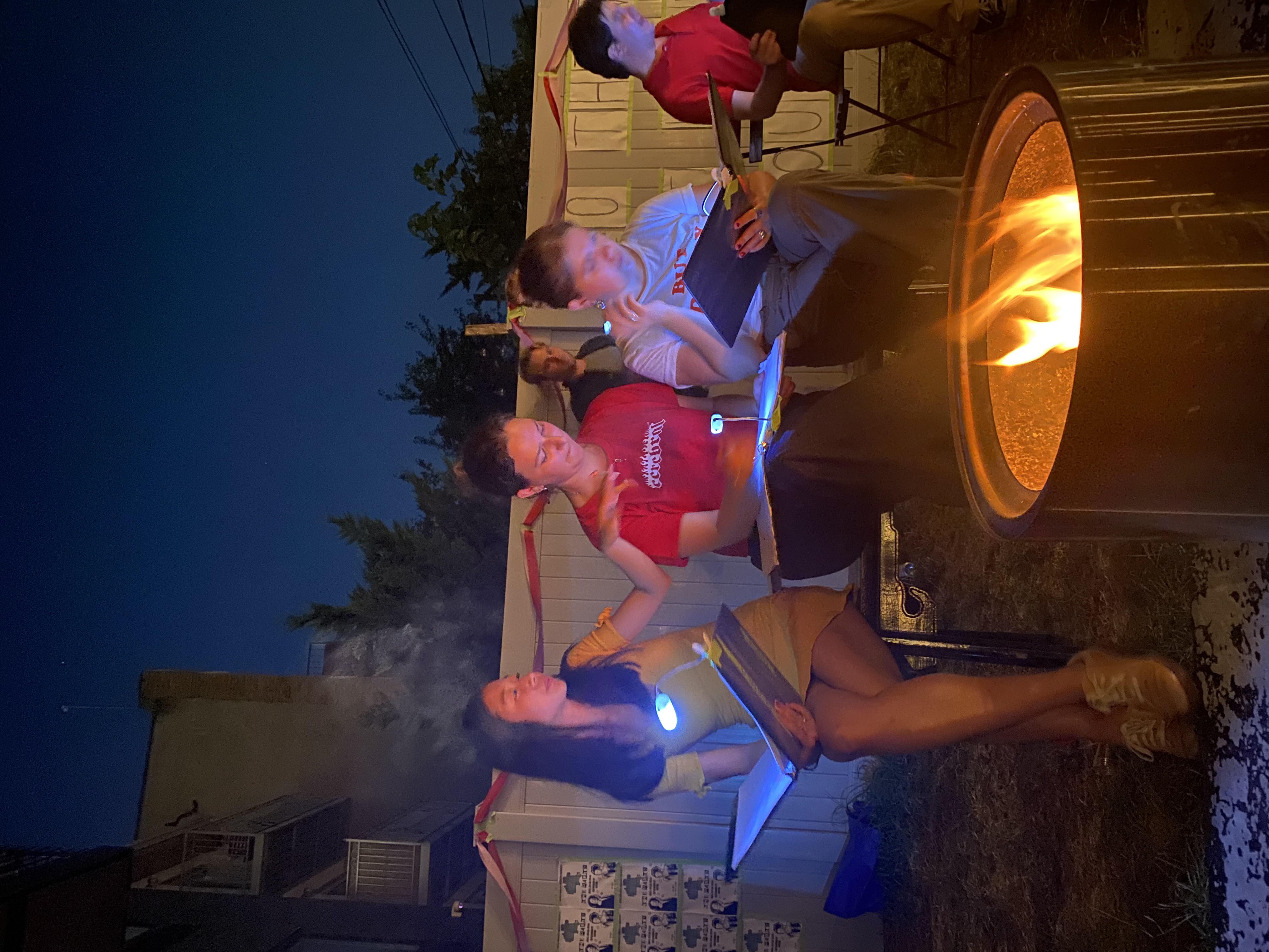 Performers read scripts by a firepit during 10 Things I Hate About You