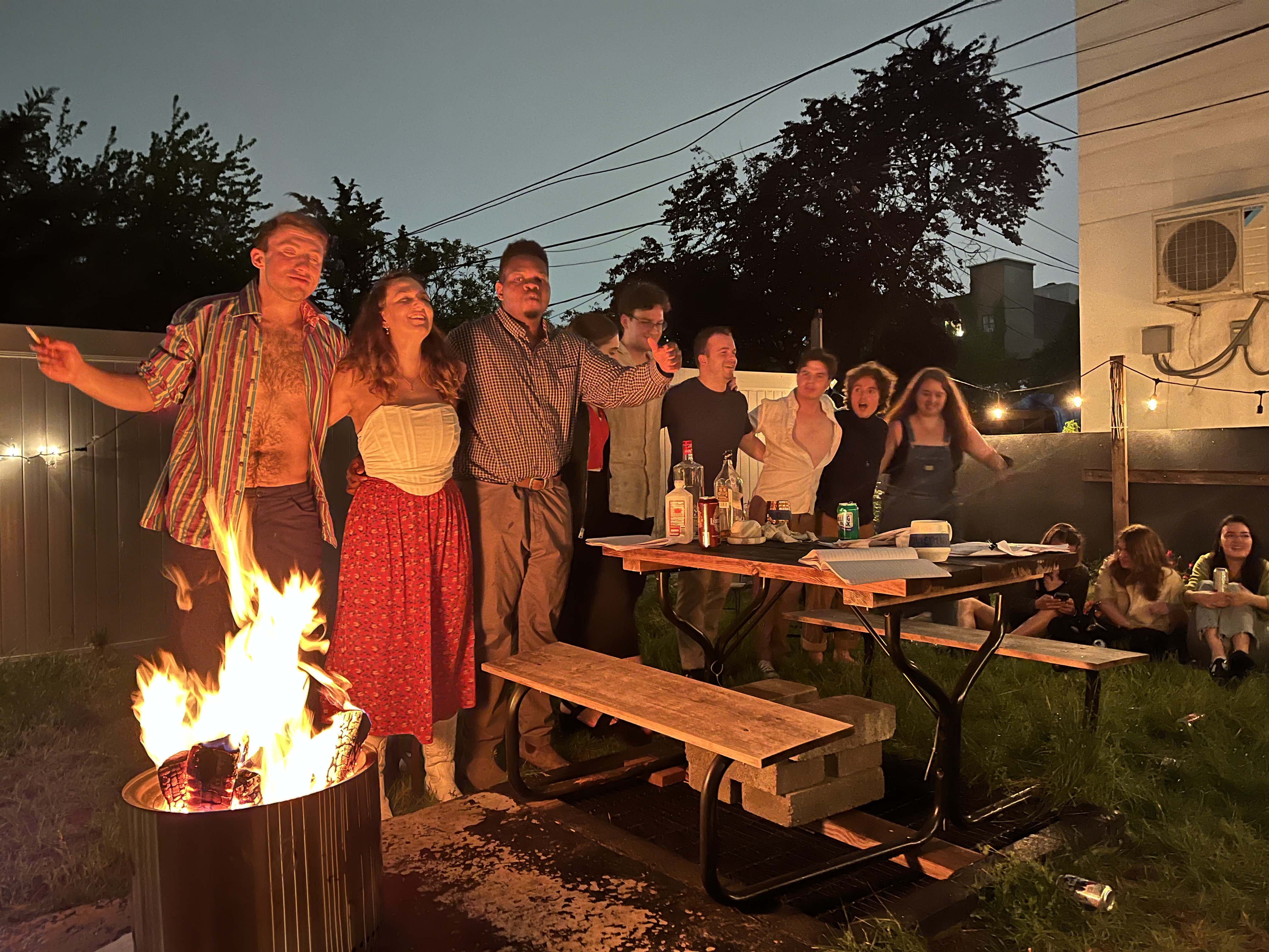 The first Live Animals Onstage Seagull production gathers around a backyard fire
