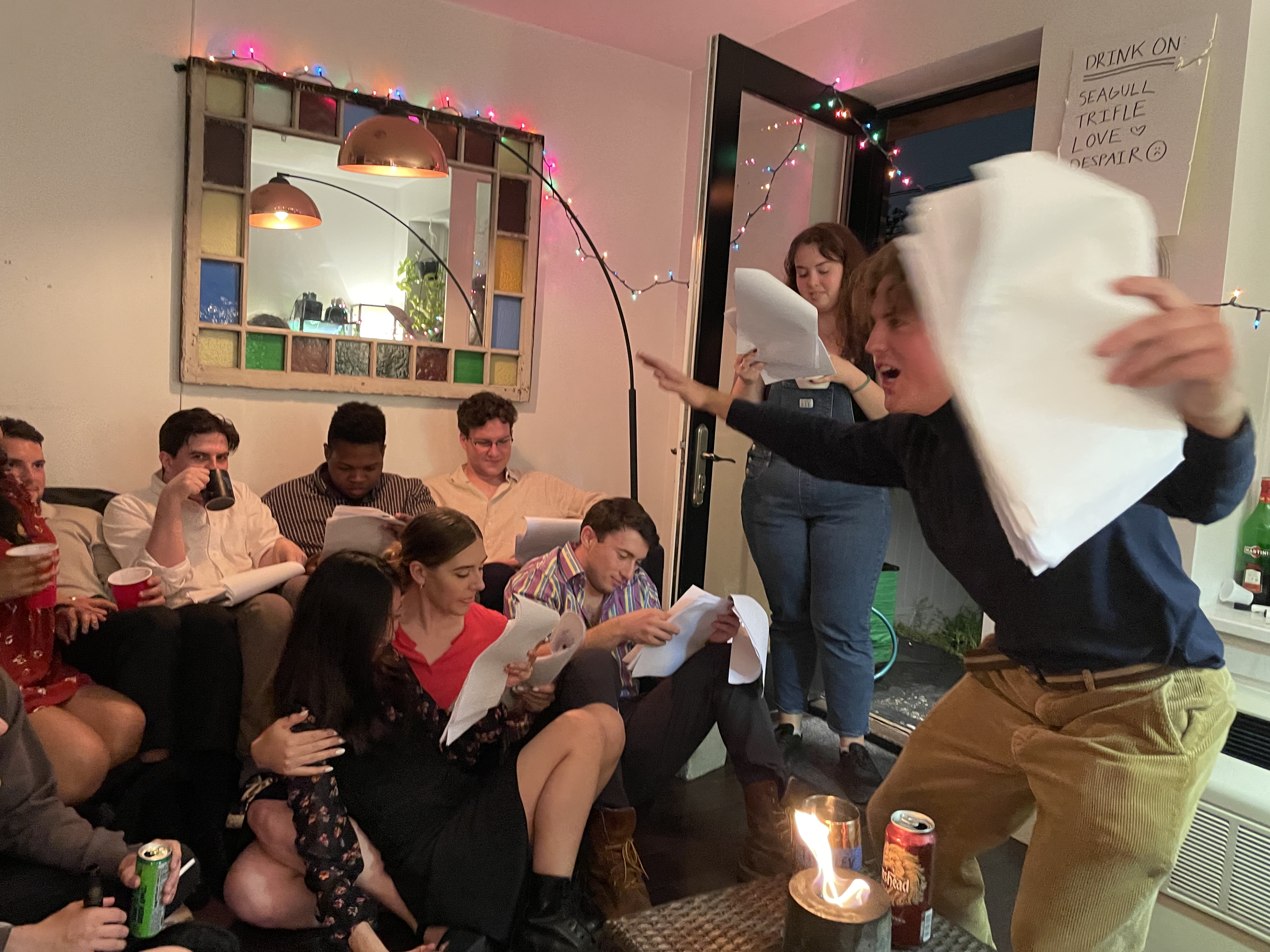 The Seagull performers with scripts in a packed living room