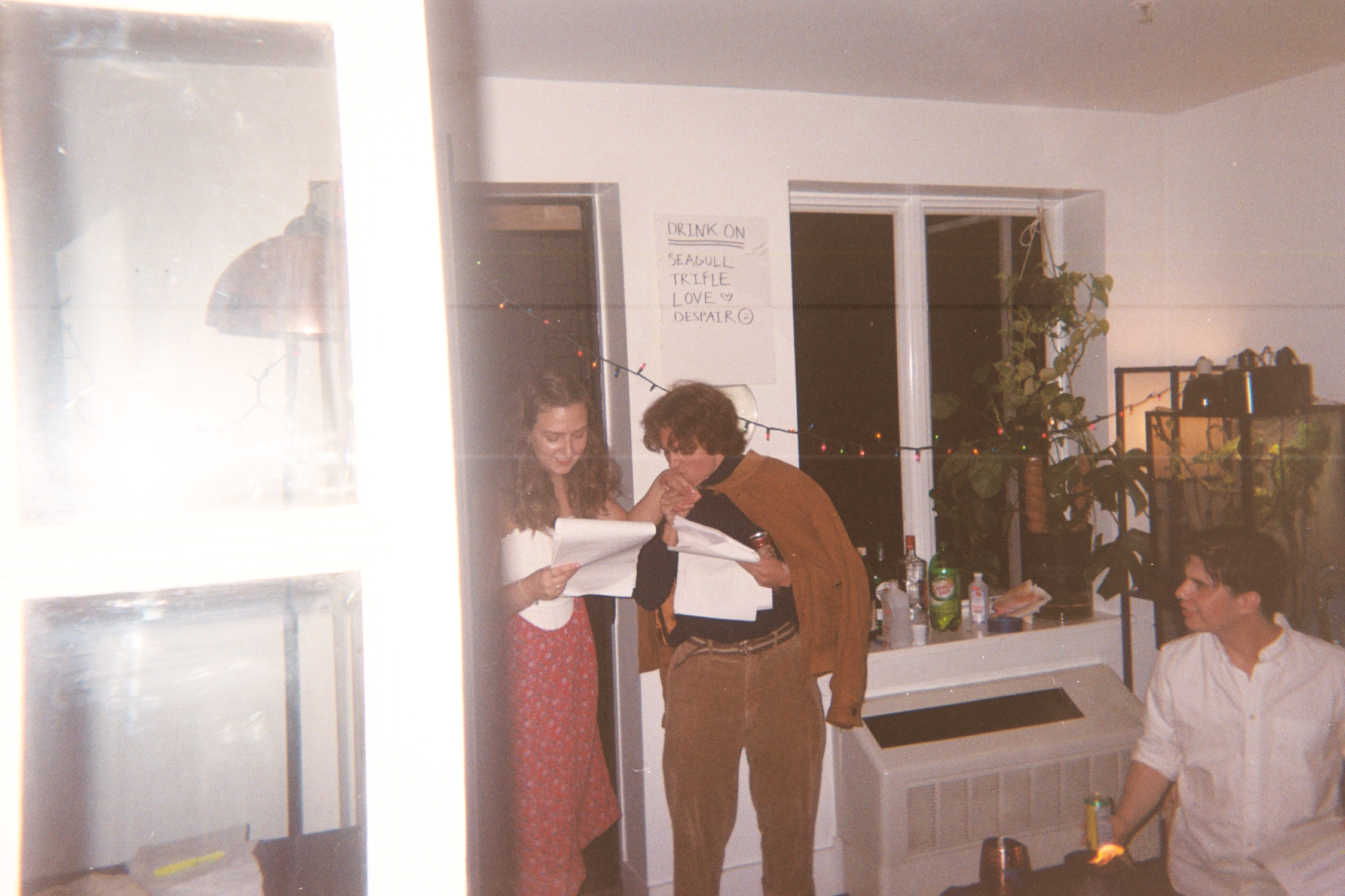 Fiona Selmi and John Murphy beside the handwritten Seagull drink sign