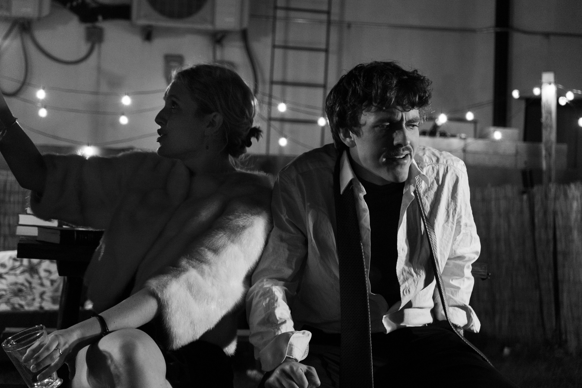 A black-and-white image of Honey and George seated on a couch