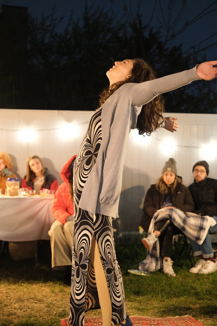 Martha stretches her arms out while dinner guests watch